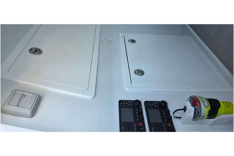 Slide: The Image of 2024 Costa Custom Boats 34 SV interior with control panels and storage compartments. - 59