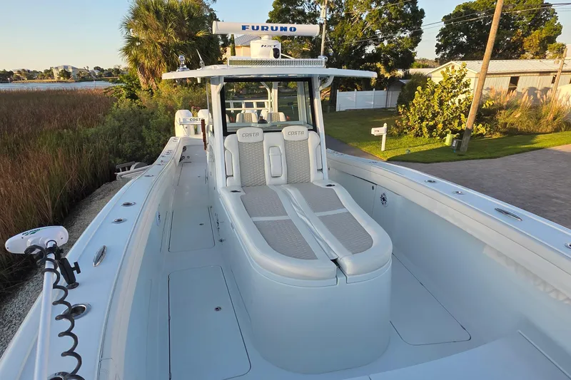 Slide: The Image of 2024 Costa Custom Boats 34 SV, sleek design, spacious deck, modern seating, outdoor setting. - 6