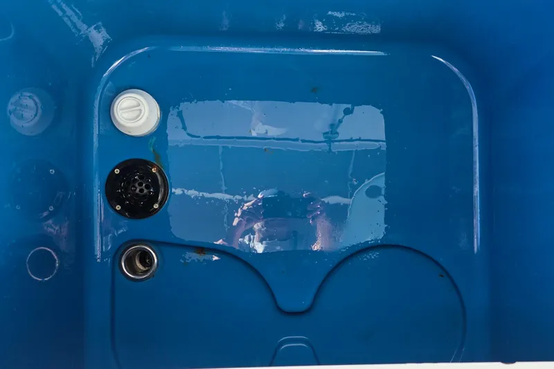 Slide: The Image of Blue interior of 2024 Costa Custom Boats 34 SV, featuring drainage and control elements. - 61