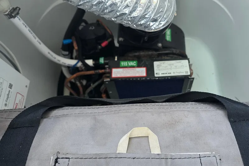 Slide: The Image of 2024 Costa Custom Boats 34 SV engine compartment with visible wiring and components. - 66