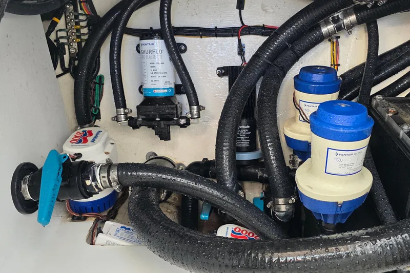 Slide: The Image of 2024 Costa Custom Boats 34 SV engine compartment with pumps and hoses. - 69