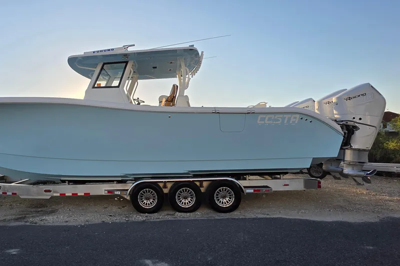 Slide: The Image of 2024 Costa Custom Boats 34 SV helm with dual screens displaying navigation and a live show. - 7