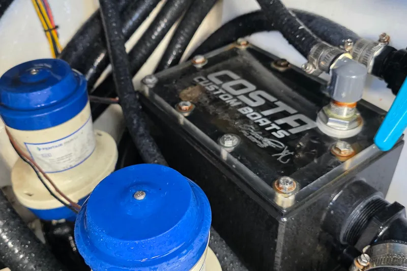 Slide: The Image of 2024 Costa Custom Boats 34 SV engine compartment with wiring and components. - 70