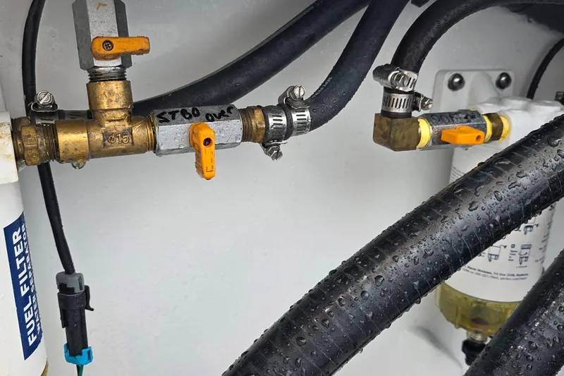 Slide: The Image of Fuel system components in a 2024 Costa Custom Boats 34 SV, featuring hoses and valves. - 71
