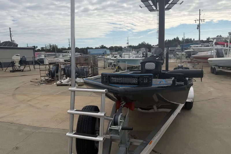 Slide: The Image of 2025 Timber Creek 2064 boat on trailer at a marina with other boats. - 11