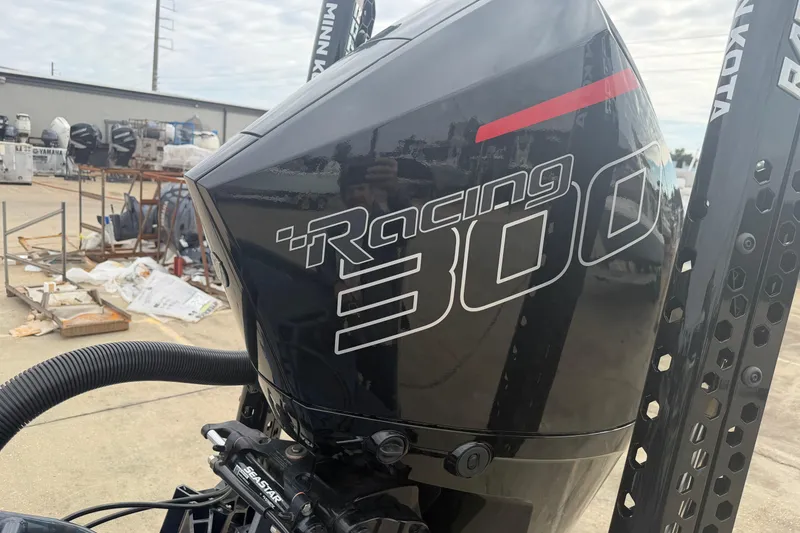 Slide: The Image of Timber Creek 2064 Racing 300 outboard motor, 2025 model, in a boatyard setting. - 16