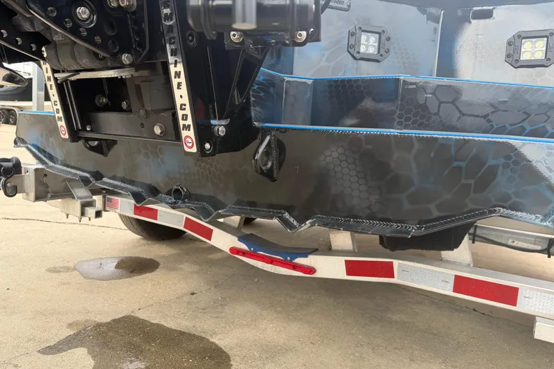 Slide: The Image of Rear view of a 2025 Timber Creek 2064 boat on a trailer, showcasing its detailed hull design. - 19