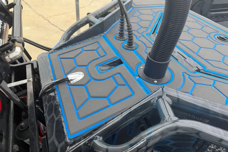 Slide: The Image of 2025 Timber Creek 2064 boat deck with blue accents and cable management system. - 24