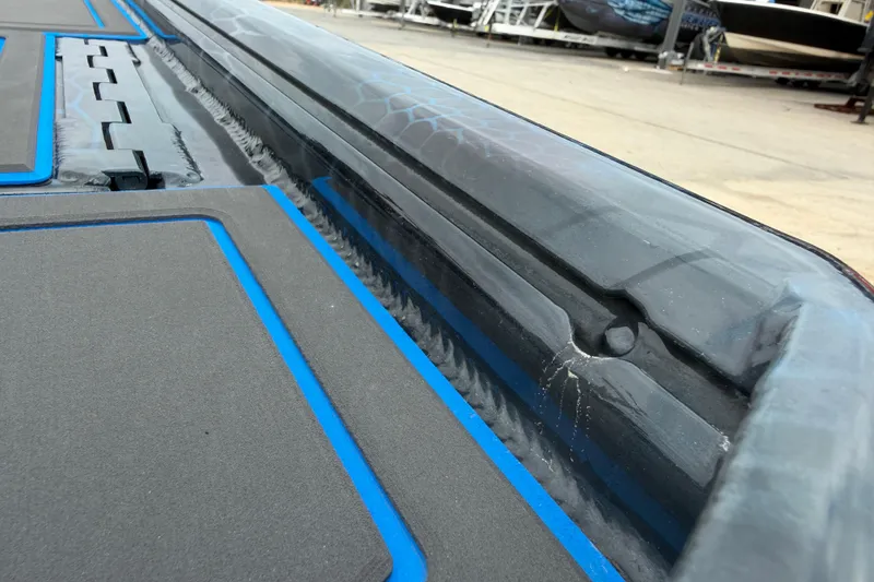 Slide: The Image of 2025 Timber Creek 2064 boat deck with blue accents, close-up view. - 25