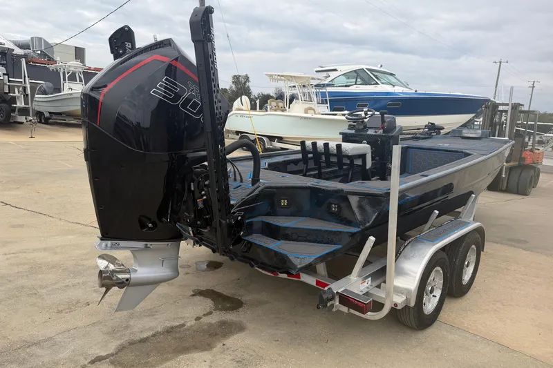 Slide: The Image of 2025 Timber Creek 2064 boat on trailer with powerful outboard motor in marina setting. - 3