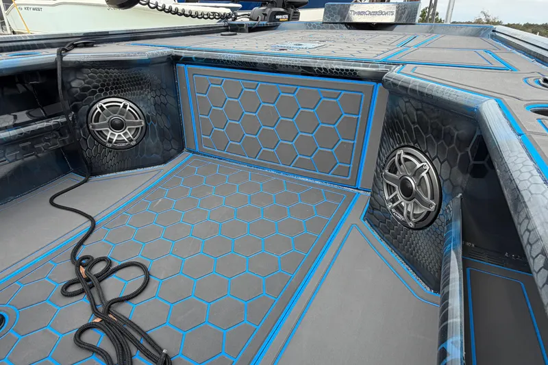 Slide: The Image of 2025 Timber Creek 2064 boat interior with hexagonal pattern and speakers. - 32