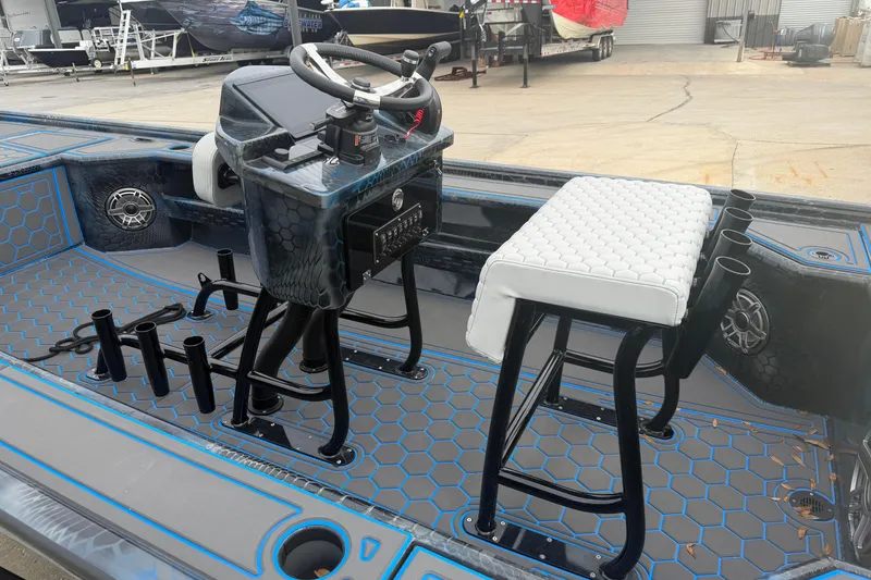 Slide: The Image of 2025 Timber Creek 2064 boat interior with hexagonal pattern flooring and white cushioned seating. - 6