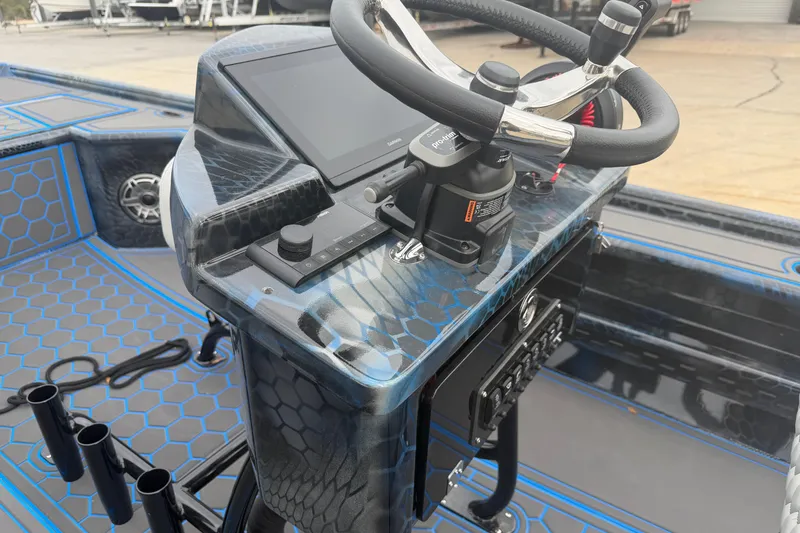 Slide: The Image of 2025 Timber Creek 2064 boat dashboard with steering wheel and control panel. - 8