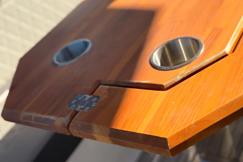 Slide: The Image of Wooden table with cup holders on NX Boats 360 Sport Coupe, 2023 model. - 12