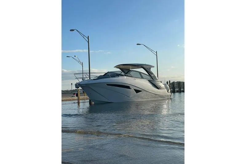 Slide: The Image of 2023 NX Boats 360 Sport Coupe docked at marina with Mercury engine. - 2