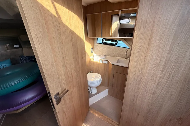 Slide: The Image of 2023 NX Boats 360 Sport Coupe bathroom with wooden interior and modern fixtures. - 22