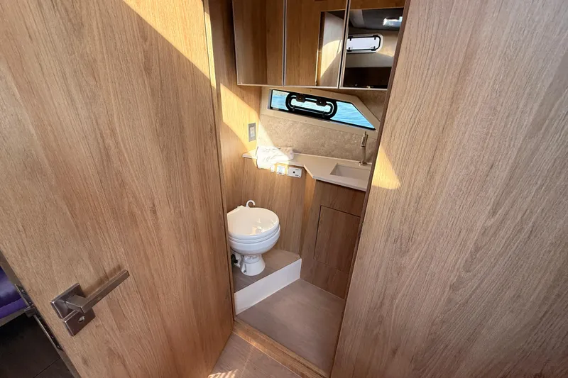 Slide: The Image of 2023 NX Boats 360 Sport Coupe bathroom with wood finish and modern fixtures. - 23