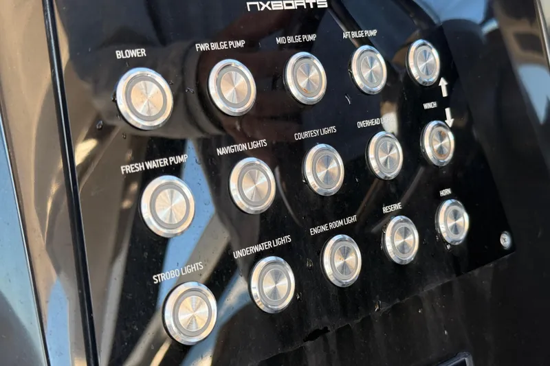 Slide: The Image of Control panel of 2023 NX Boats 360 Sport Coupe with labeled buttons for various functions. - 35