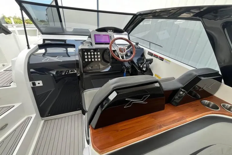 Slide: The Image of 2023 NX Boats 360 Sport Coupe with wooden deck and ocean view. - 4