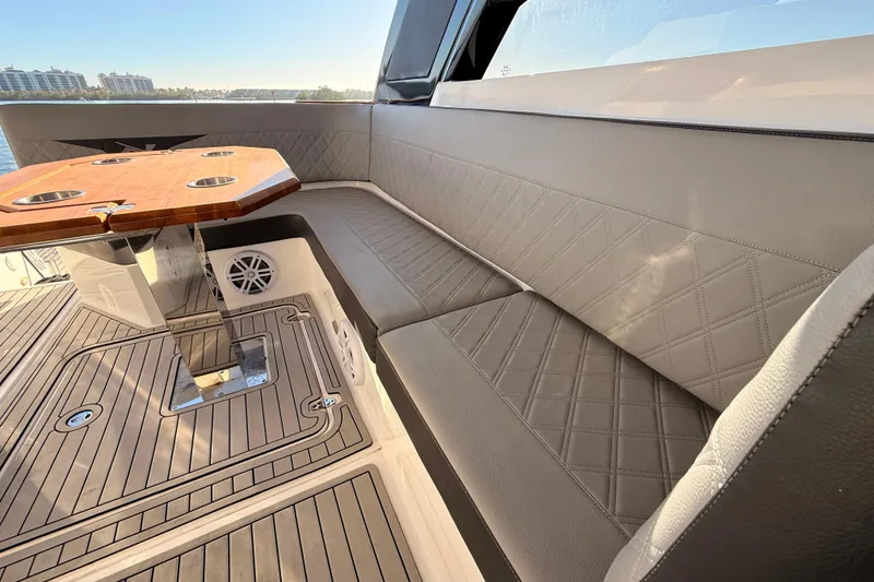 Slide: The Image of Luxurious seating area on 2023 NX Boats 360 Sport Coupe with elegant wood table. - 41