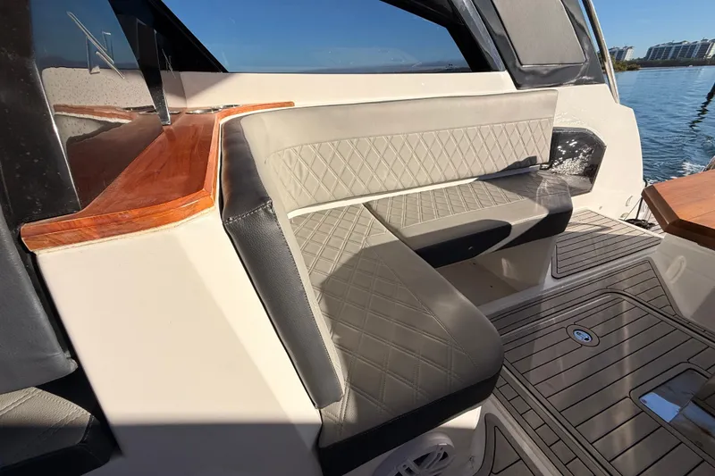 Slide: The Image of 2023 NX Boats 360 Sport Coupe interior with elegant seating and wooden accents. - 42