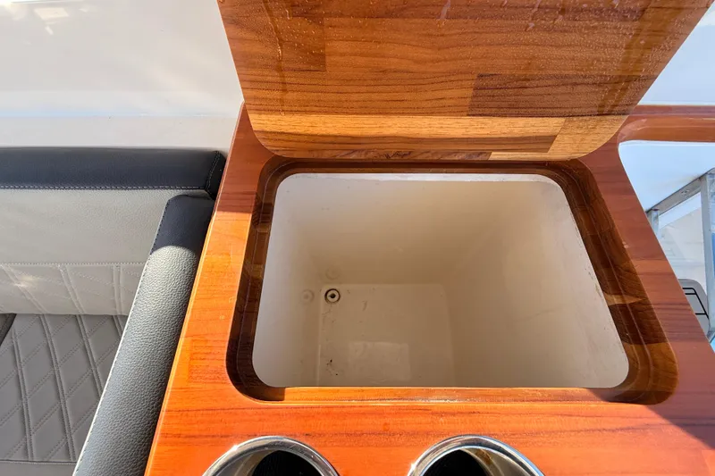 Slide: The Image of Open storage compartment on 2023 NX Boats 360 Sport Coupe with wooden finish. - 48