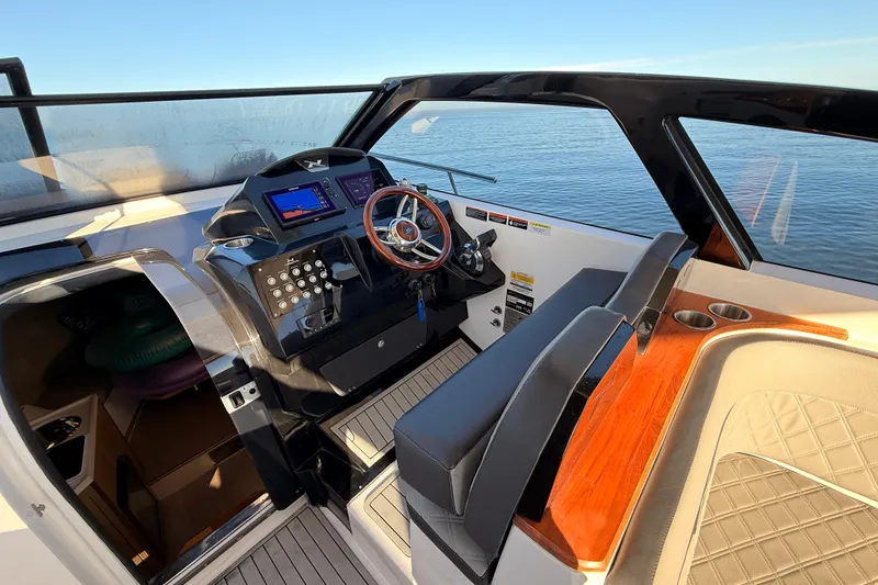 Slide: The Image of 2023 NX Boats 360 Sport Coupe cockpit with modern controls and luxurious seating. - 49