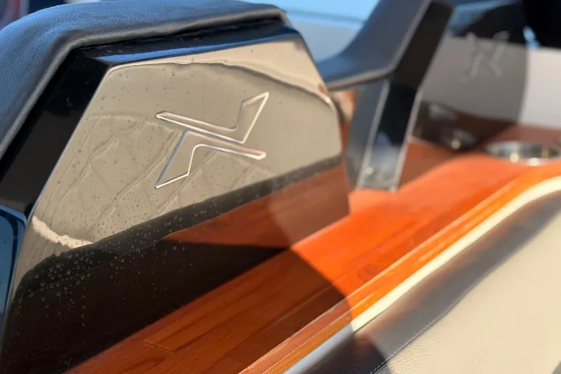 Slide: The Image of 2023 NX Boats 360 Sport Coupe interior detail with sleek design and wood accents. - 51