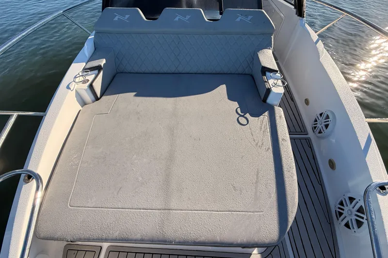 Slide: The Image of 2023 NX Boats 360 Sport Coupe deck with cushioned seating and cup holders. - 53