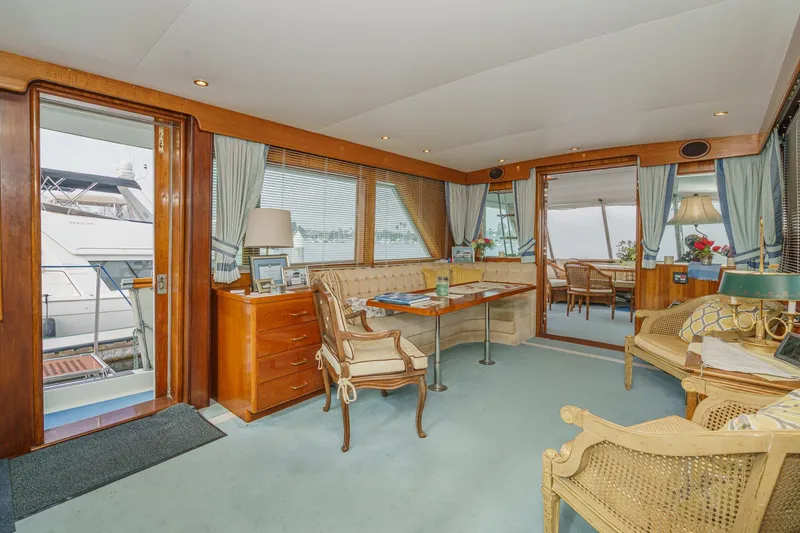 Slide: The Image of Interior of 1971 Hatteras 53 Motor Yacht with elegant seating and wooden accents. - 17