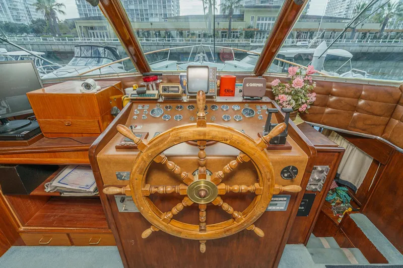 Slide: The Image of 1971 Hatteras 53 Motor Yacht helm with wooden wheel and navigation instruments. - 25