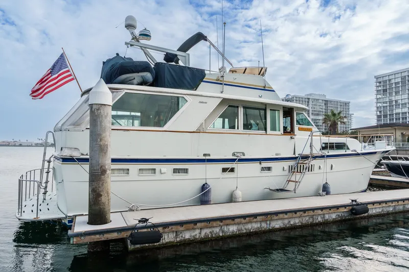Slide: The Image of 1971 Hatteras 53 Motor Yacht docked, featuring classic design and American flag. - 3