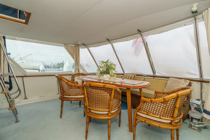 Slide: The Image of 1971 Hatteras 53 Motor Yacht interior with wicker chairs and dining table. - 30