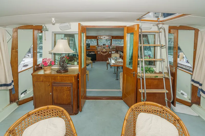 Slide: The Image of 1971 Hatteras 53 Motor Yacht interior with wooden decor and nautical furnishings. - 32