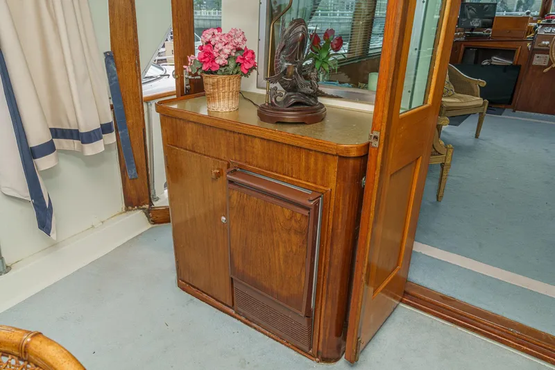 Slide: The Image of Interior of 1971 Hatteras 53 Motor Yacht with wooden cabinet and floral decor. - 33
