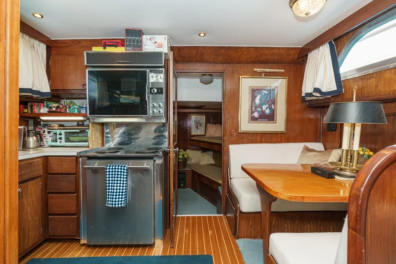 Slide: The Image of Interior of 1971 Hatteras 53 Motor Yacht with kitchen and dining area. - 38
