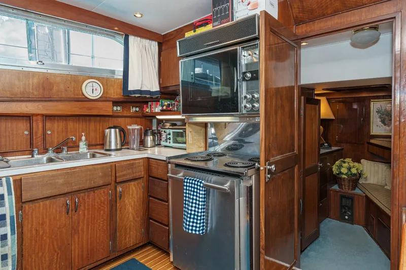 Slide: The Image of 1971 Hatteras 53 Motor Yacht kitchen with wood cabinetry and modern appliances. - 39