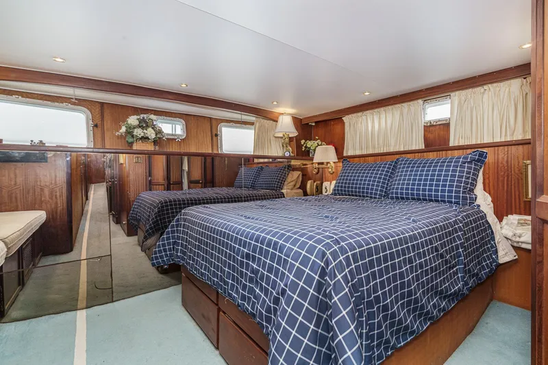 Slide: The Image of Interior of 1971 Hatteras 53 Motor Yacht with twin beds and wood paneling. - 45