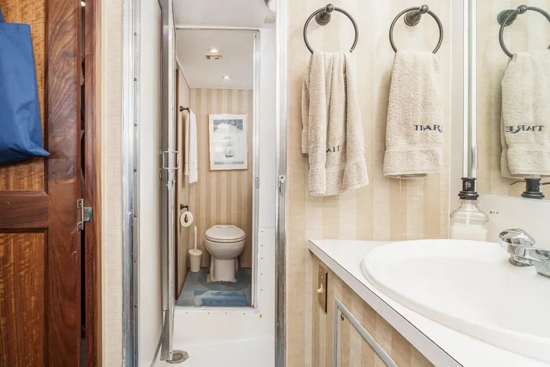 Slide: The Image of Bathroom interior of 1971 Hatteras 53 Motor Yacht with sink, towels, and toilet. - 50