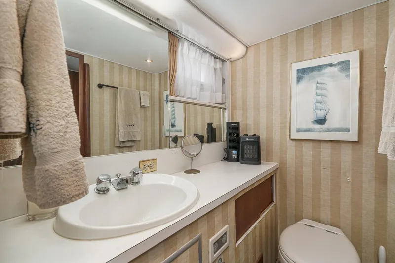 Slide: The Image of Bathroom interior of 1971 Hatteras 53 Motor Yacht with striped wallpaper and nautical decor. - 52