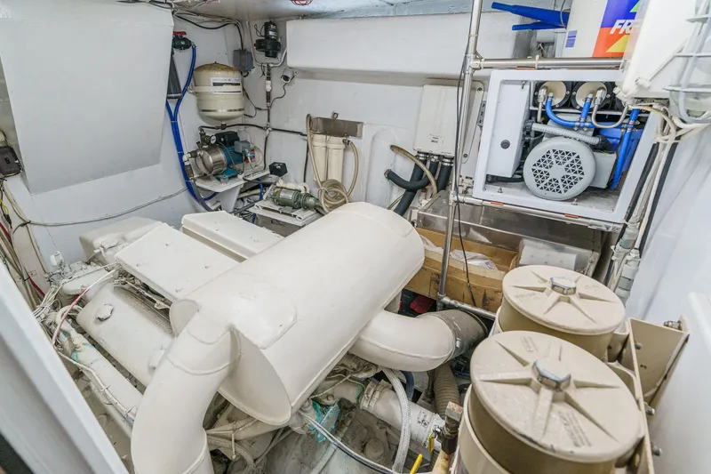 Slide: The Image of Engine room of a 1971 Hatteras 53 Motor Yacht, showcasing machinery and equipment. - 58