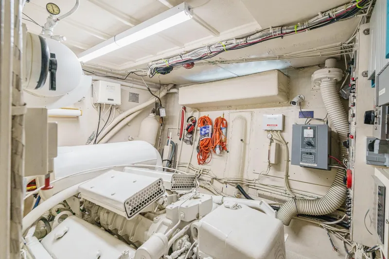 Slide: The Image of Engine room of 1971 Hatteras 53 Motor Yacht, featuring mechanical and electrical components. - 60