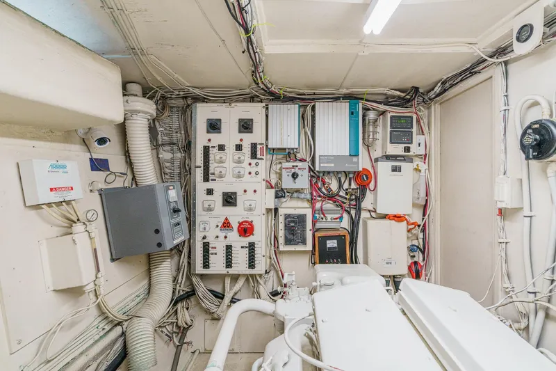 Slide: The Image of Engine room of a 1971 Hatteras 53 Motor Yacht with electrical panels and wiring. - 63