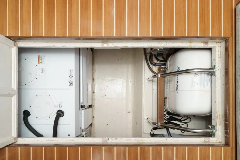Slide: The Image of Engine room of 1971 Hatteras 53 Motor Yacht with equipment and wooden flooring. - 67