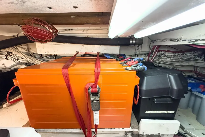 Slide: The Image of Battery compartment of a 1971 Hatteras 53 Motor Yacht with orange and black battery boxes. - 70