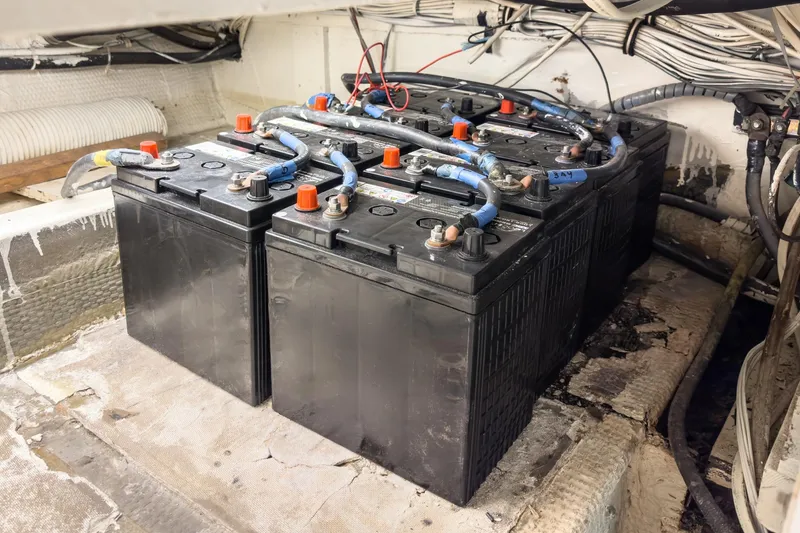Slide: The Image of Battery compartment of a 1971 Hatteras 53 Motor Yacht, showcasing multiple connected batteries. - 71