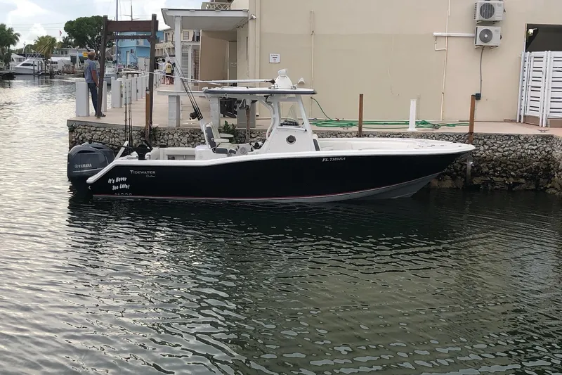 The Image of 2016 Tidewater 280 CC Adventure boat docked in a marina, featuring Yamaha engines. - 1
