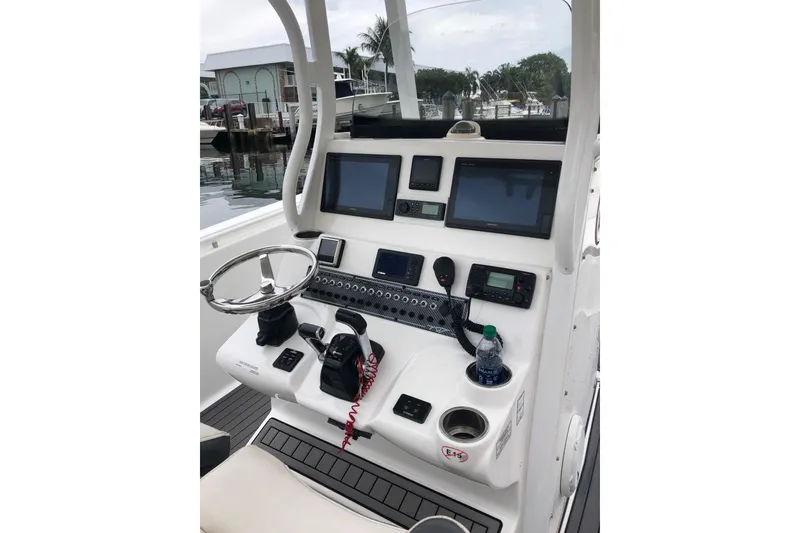 Slide: The Image of 2016 Tidewater 280 CC Adventure boat console with steering wheel and navigation screens. - 4