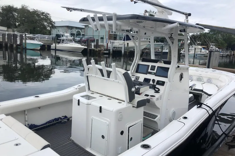 Slide: The Image of 2016 Tidewater 280 CC Adventure boat with modern console and seating at a marina. - 5