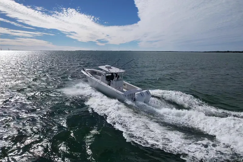 Slide: The Image of 2024 Front Runner 33 Center Console boat cruising on open water under a blue sky. - 11